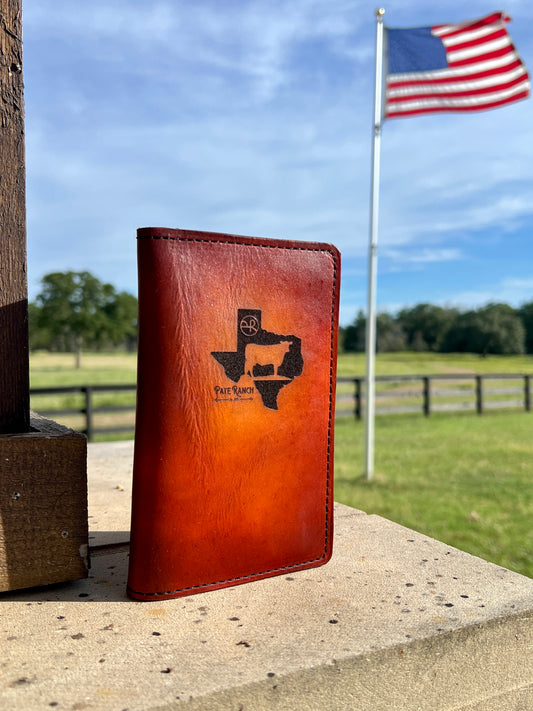 Leather tally book with Texas design on it with an American flag in the background