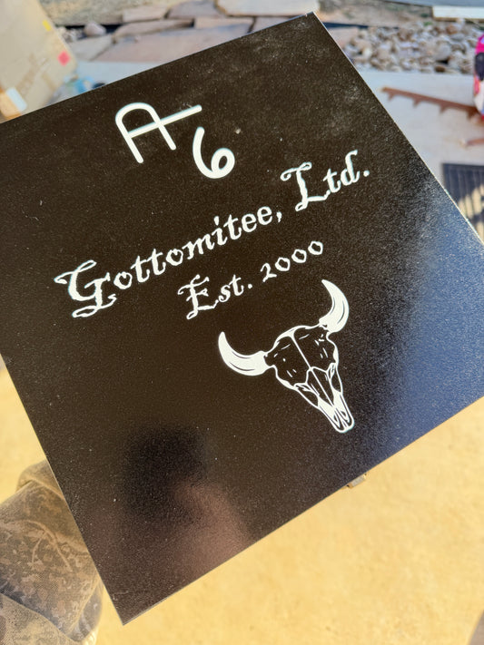 Black card with white text and logo on a textured surface