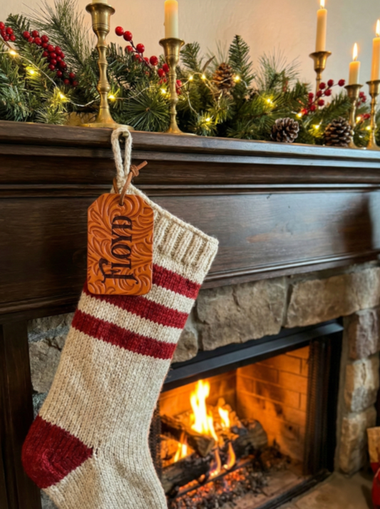 Leather name tag on a stocking with a Christmas background