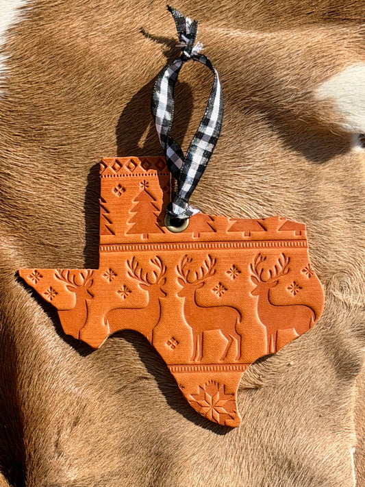 Decorative Texas-shaped ornament with reindeer design on a fur background