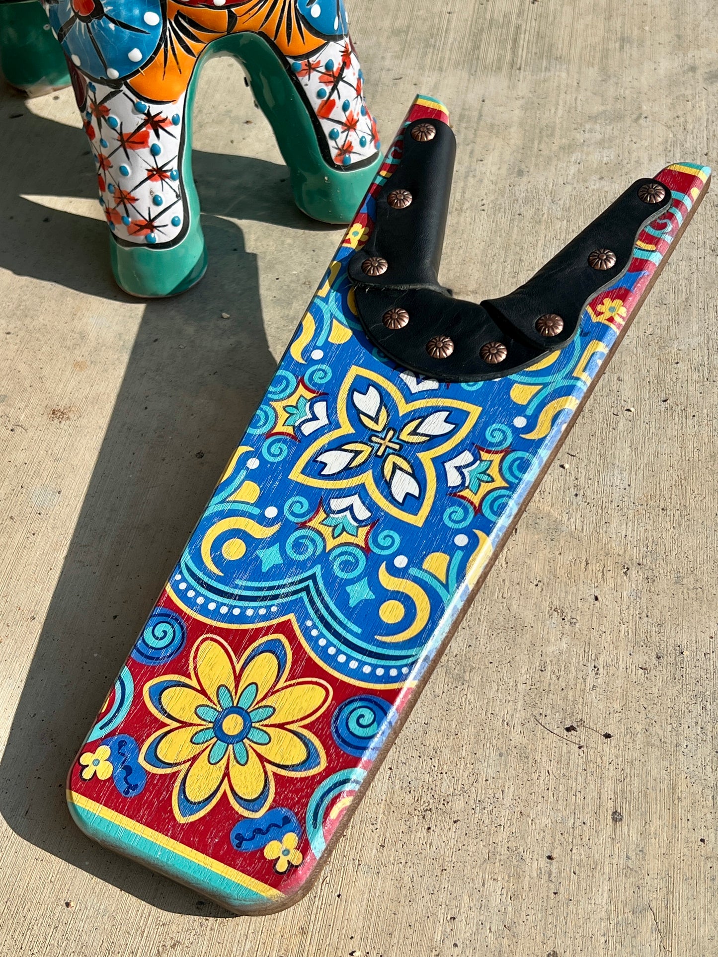 Colorful patterned tool holder on a concrete surface