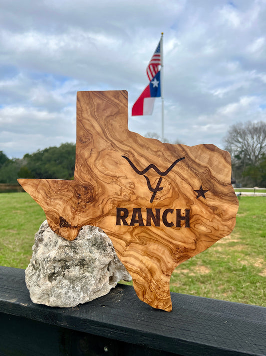 Texas-shaped charcuterie board made from hand-picked olive wood 16 inches wide with unique natural grain perfect for serving or gifting