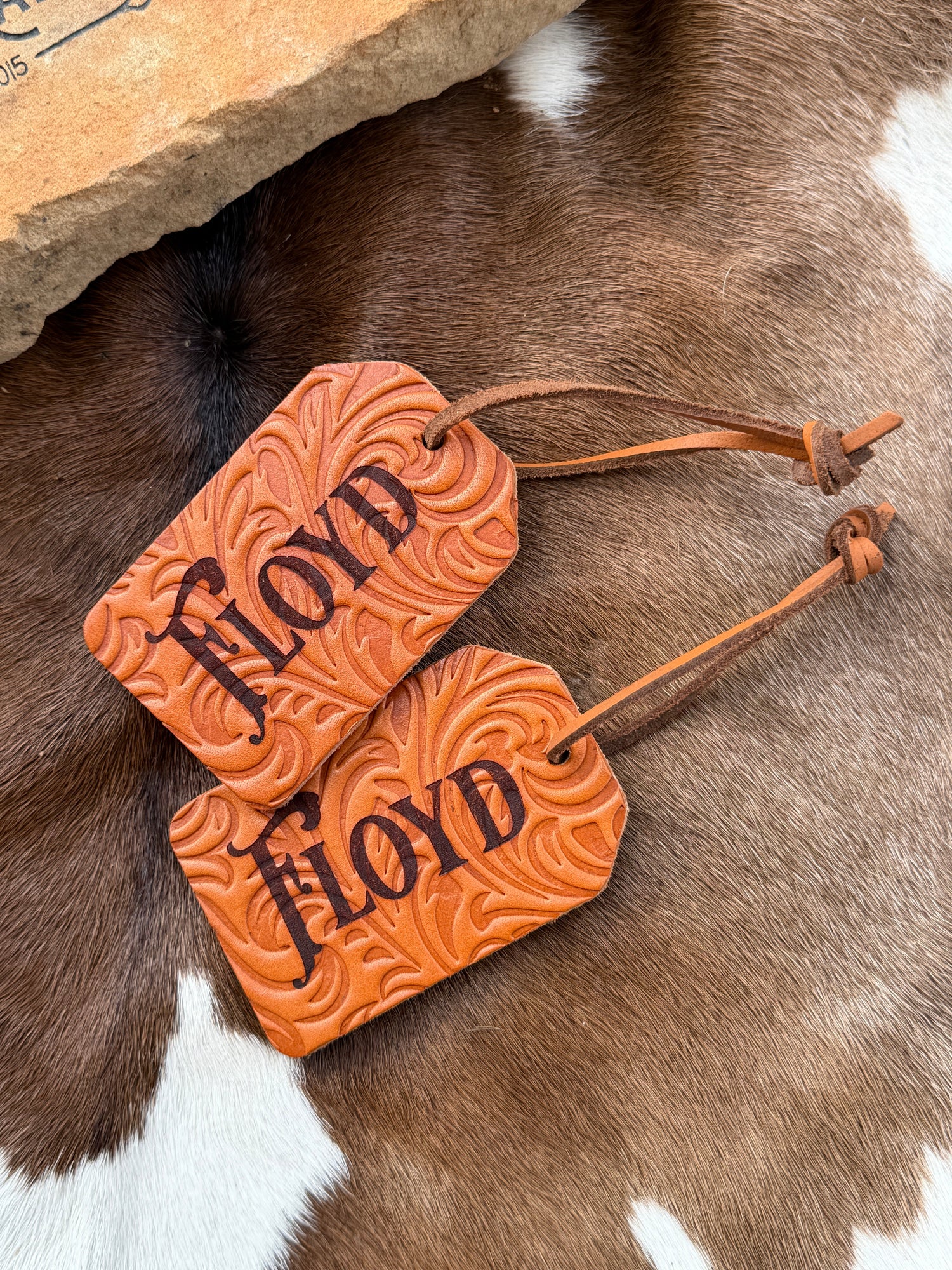 Custom Western Leather Tags on a cowhide