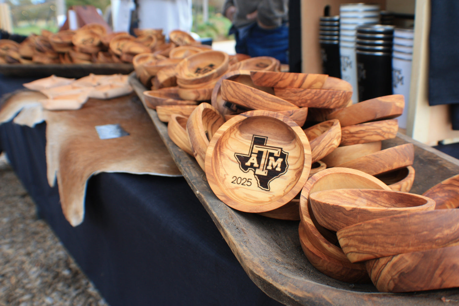 Table of personalized wooden Texas A&M Aggie ring dishes for ring ceremony day 