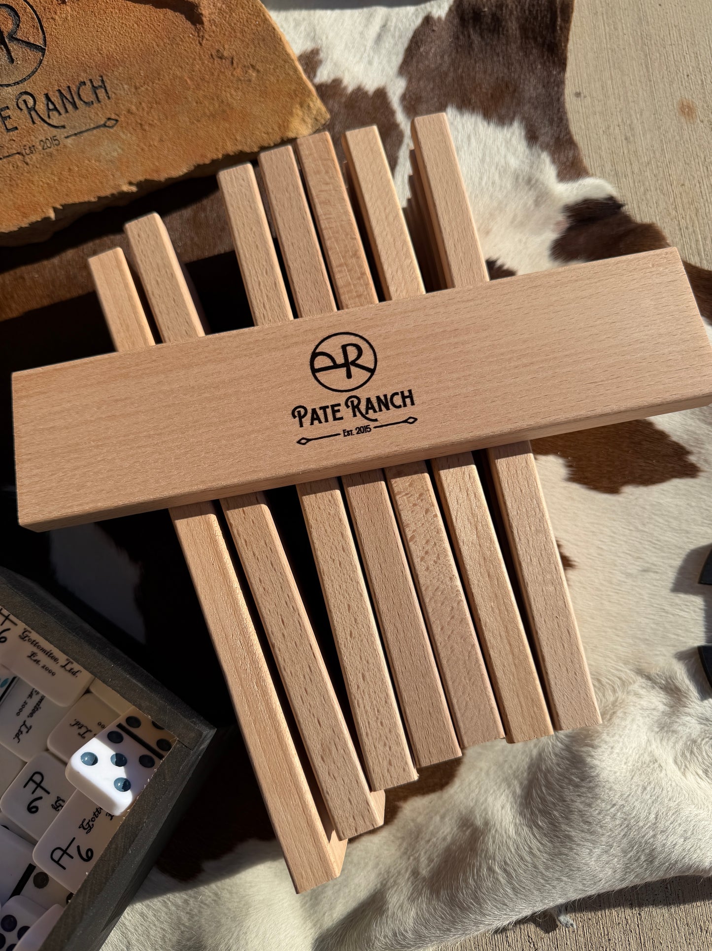 Wooden tool with 'Pate Ranch' branding on a textured surface