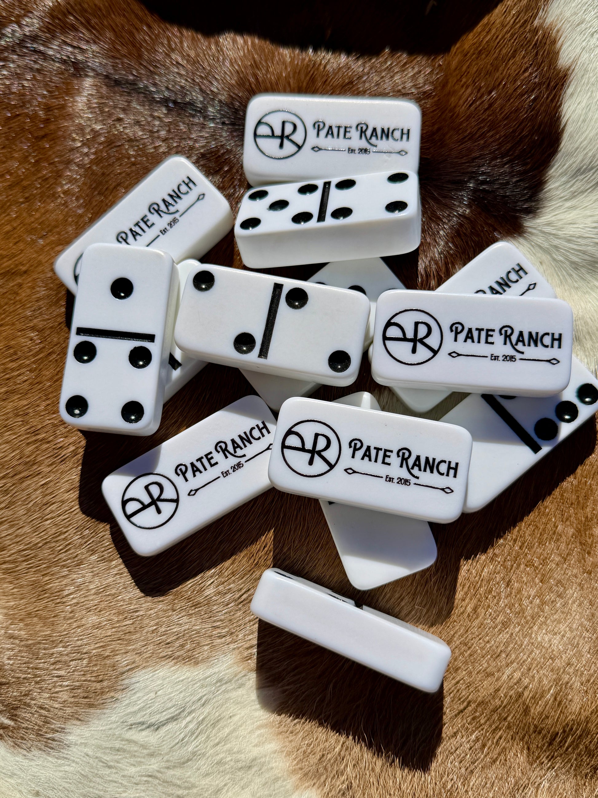 Dominoes set with 'Pate Ranch' branding on a fur background