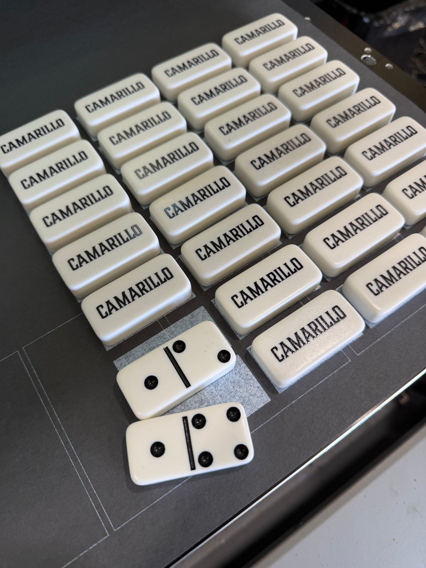Dominoes set with two dice on a dark surface