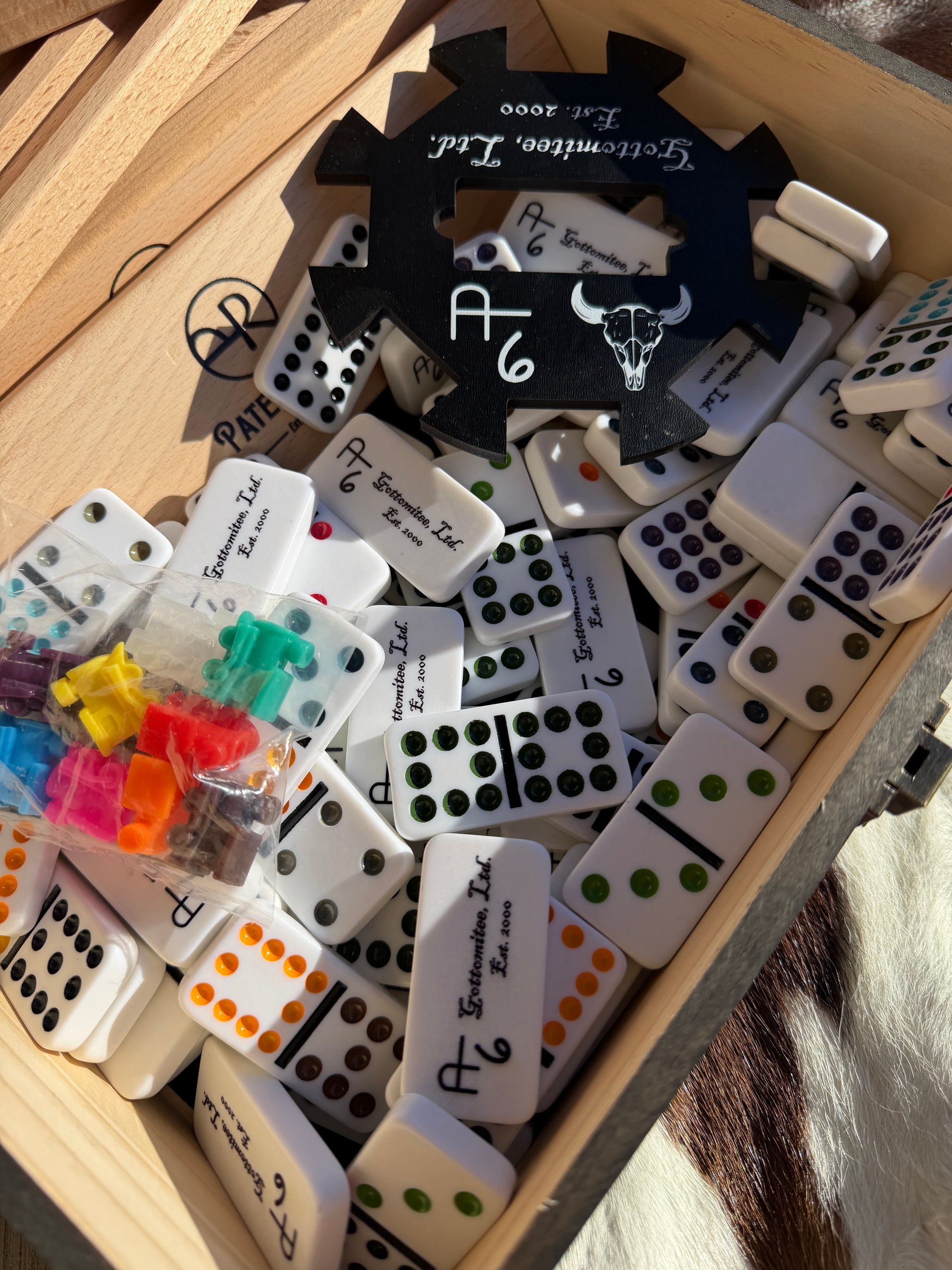 Collection of assorted dominoes in a wooden box