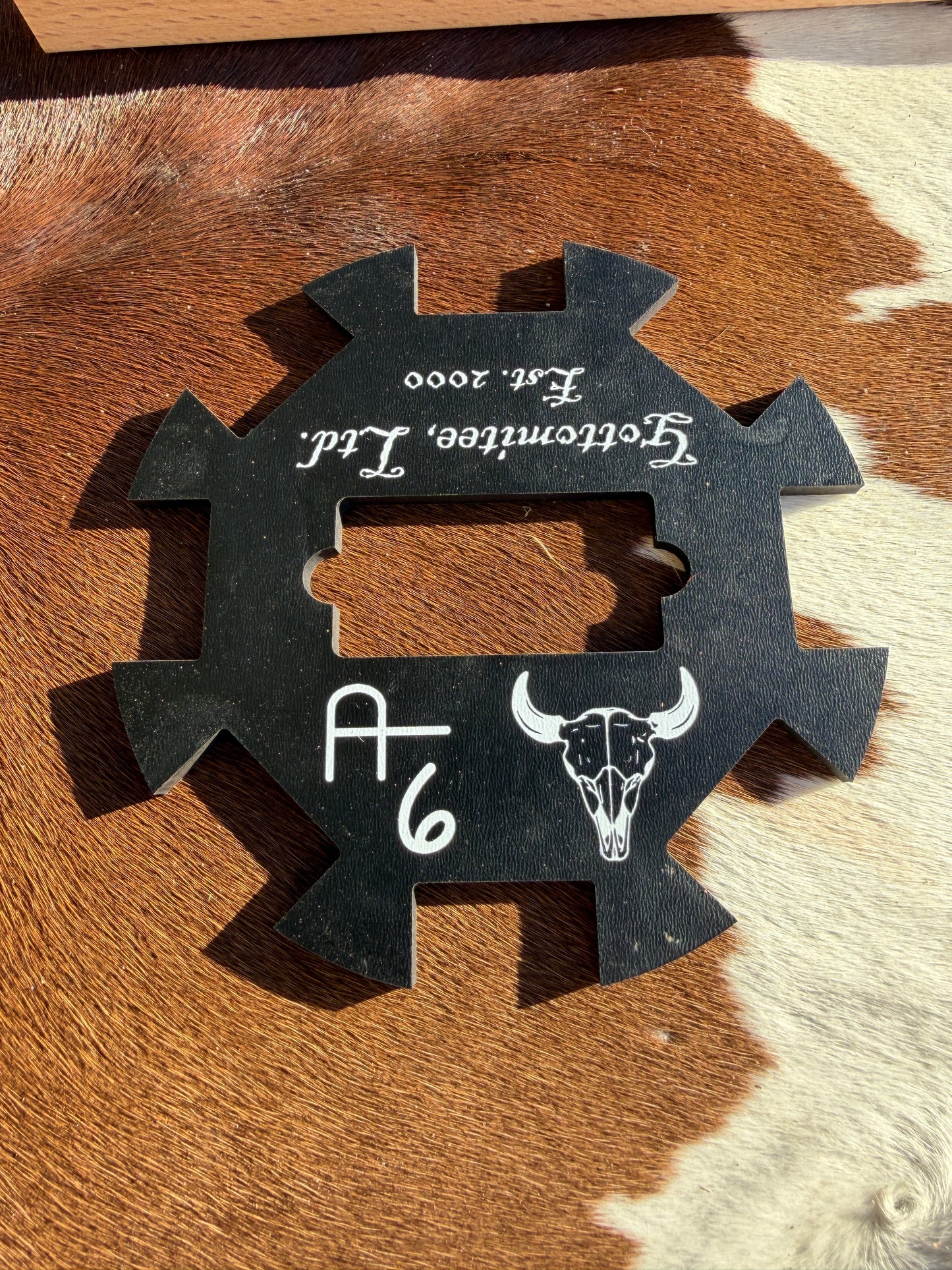 Black wood tool with brand name on a brown and white fur background