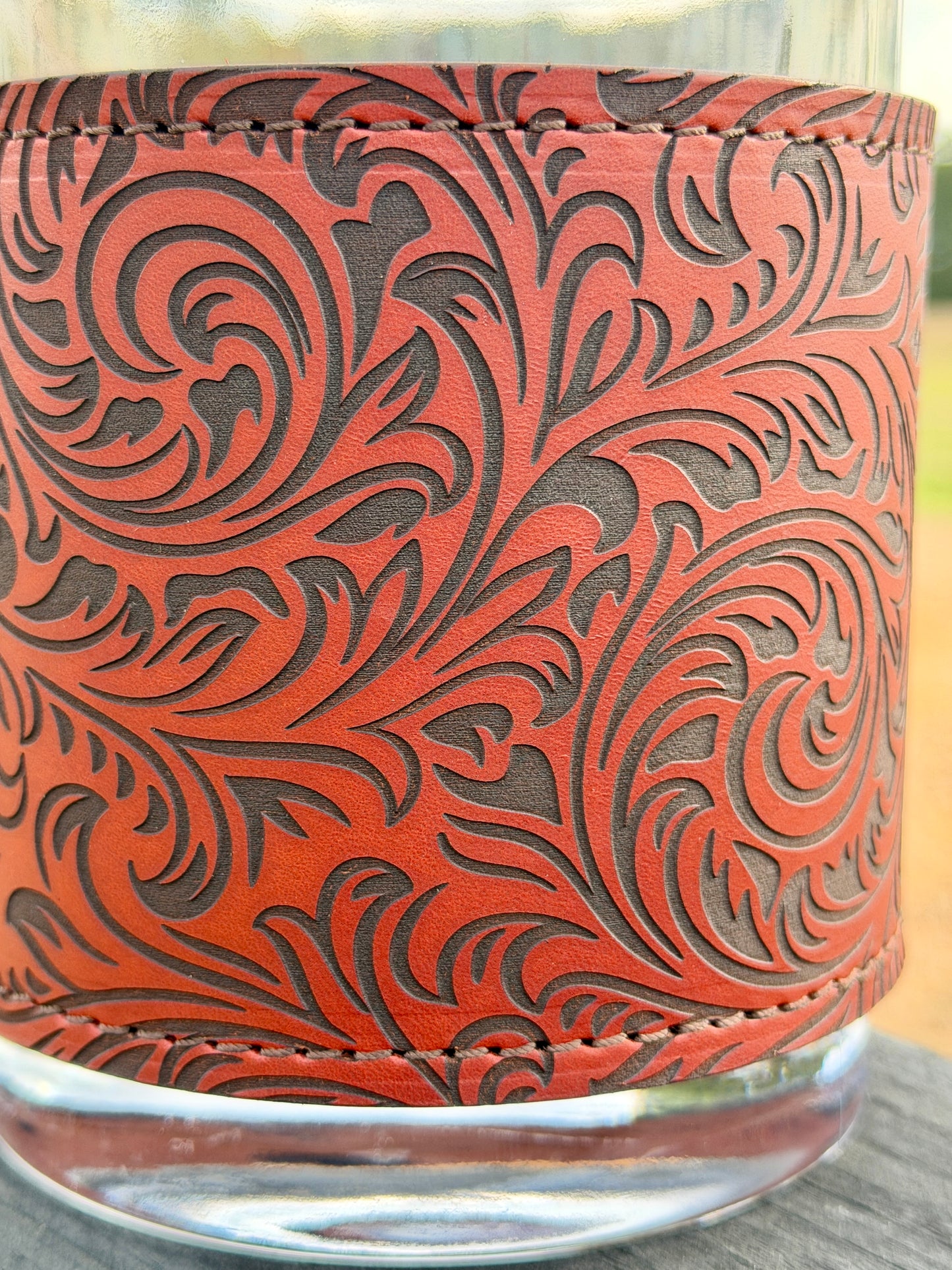 Decorative glass container with intricate leather-like pattern