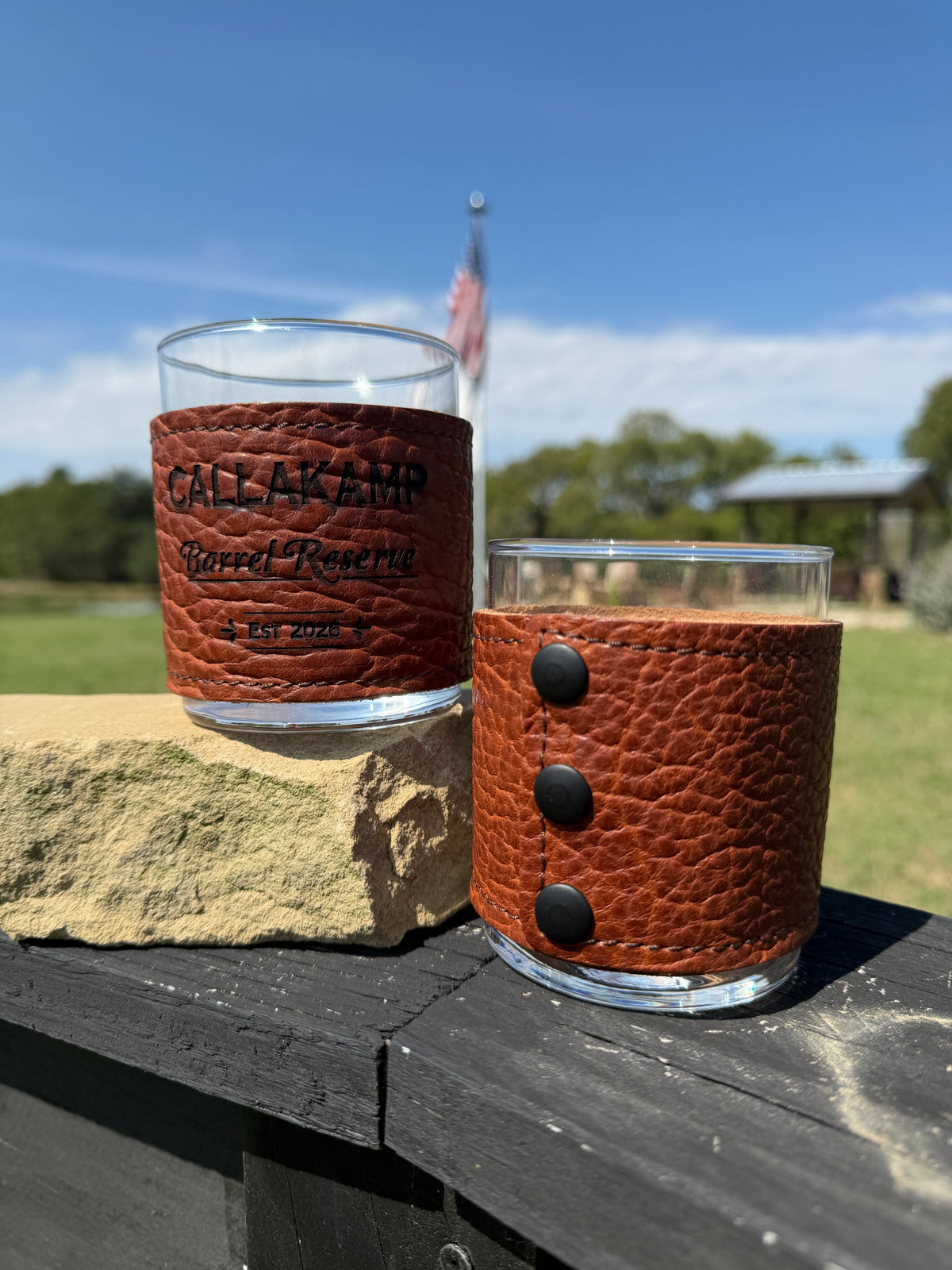 Bison leather bourbon glasses showing personalized front engraving and black rivets on the back
