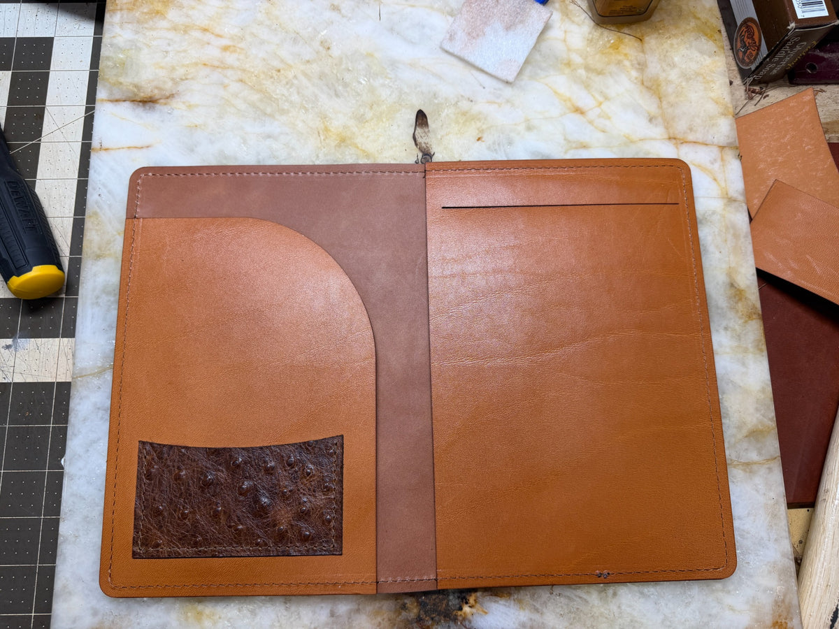 Open A5 leather padfolio showing document pocket and writing pad area