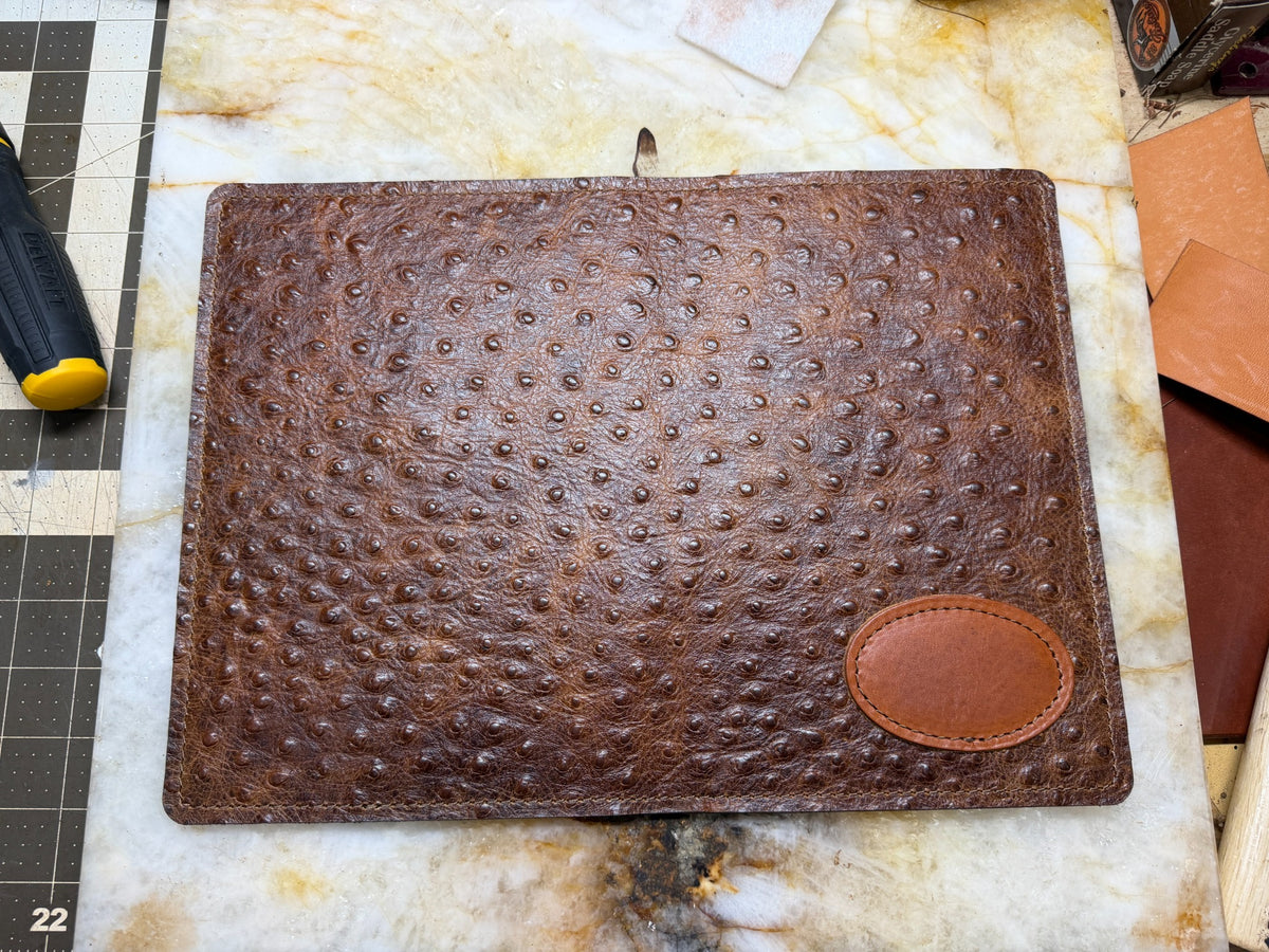 Ostrich-style leather A5 padfolio exterior with stitched personalization patch