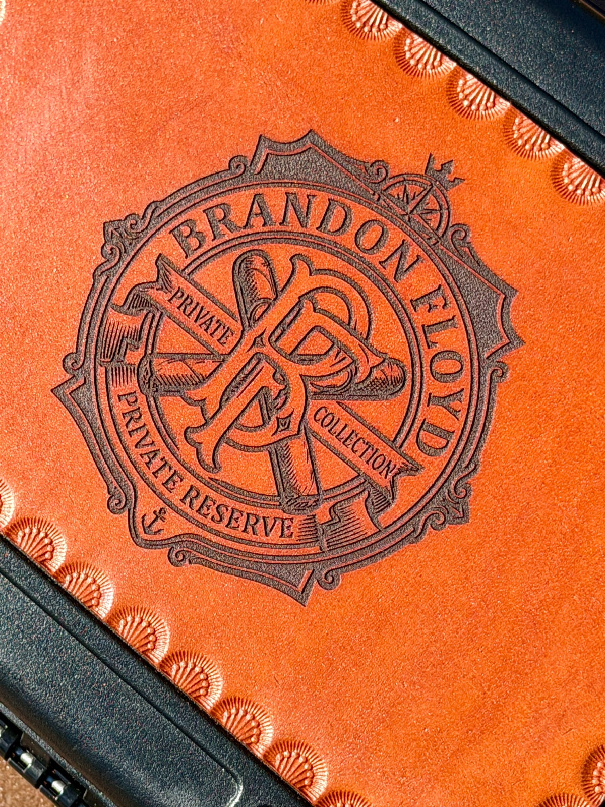 Detail of laser engraved crest on genuine bridle leather cigar travel case