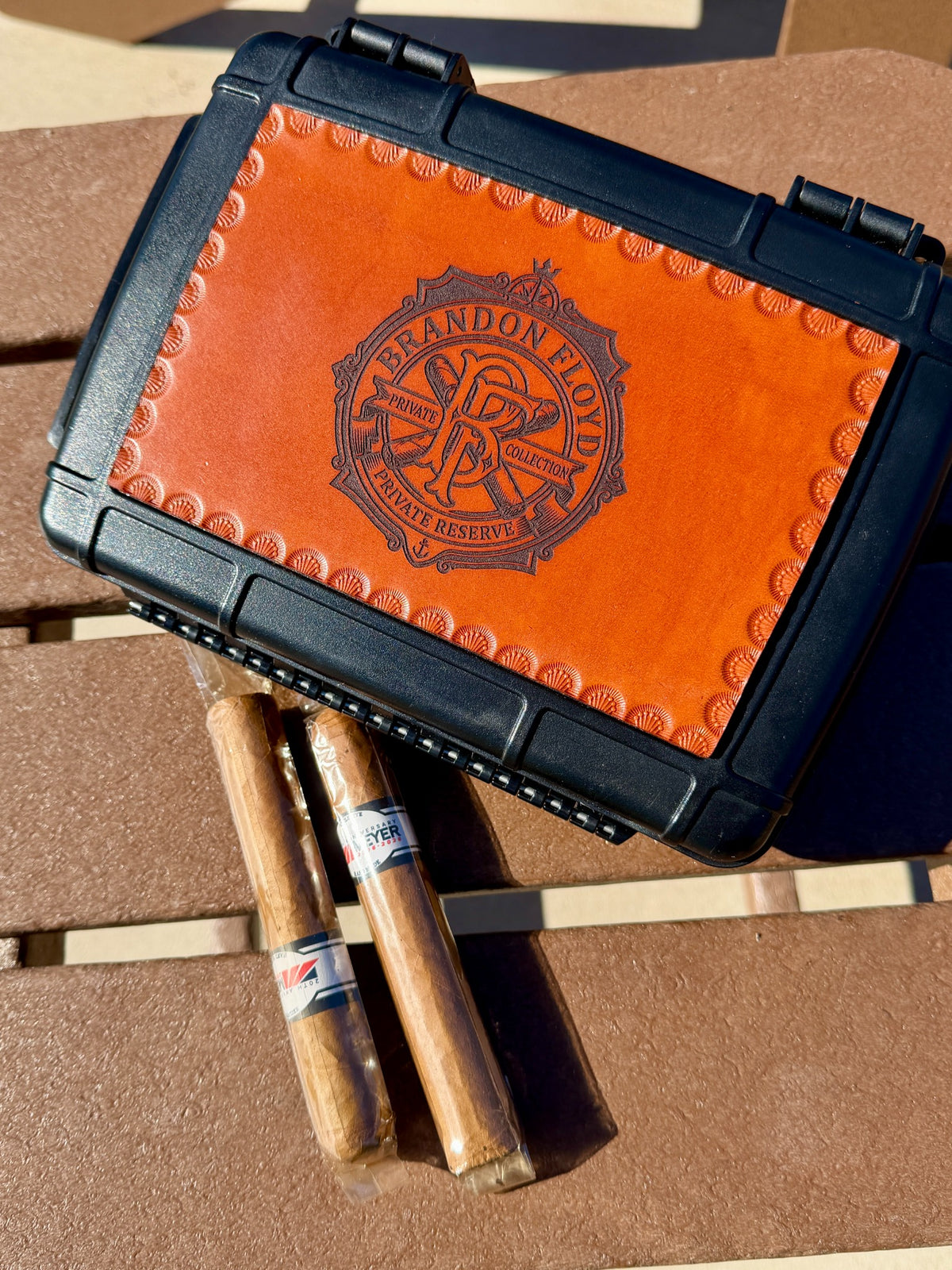 Angled view of tooled and personalized leather top cigar case