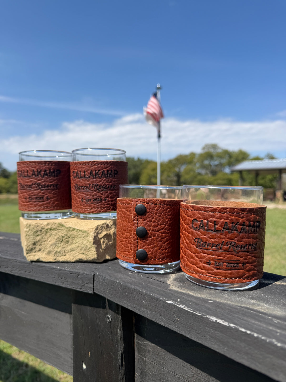Genuine bison leather bourbon glasses showing engraving and black rivet details